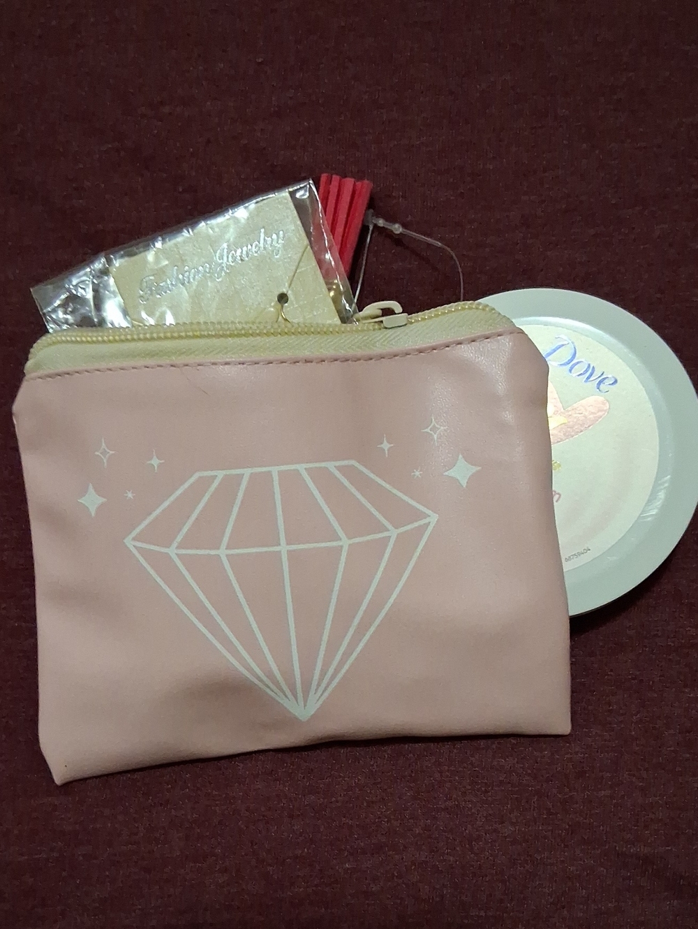 Pink Jewelry mystery pouch and Dove facial cream